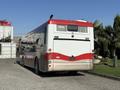 A 2016 Grande West Vicinity bus displayed from the rear with a red and white color scheme and large rear lights