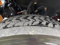 Close-up of a tire tread on a 2020 Lion Lion6 showing a pronounced zigzag pattern with dirt and wear visible on the surface
