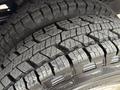 Close-up of the tire tread of a 2013 RAM 3500 showcasing deep grooves and a rugged design meant for off-road traction and durability