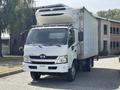 A 2018 Hino 195 truck with a refrigerated box on the back and a front grille featuring the Hino logo