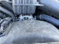 Engine components of a 2016 Ford F-250 SD including the alternator and surrounding parts with visible wires and a black cover