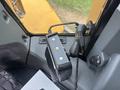 A close-up view of a control panel featuring buttons and a display inside a 2012 Caterpillar 980 machinery cabin