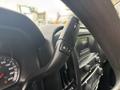 Close up of the gearshift lever of a 2016 GMC Sierra 1500 showing controls for manual shifting and cruise control settings