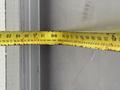 A measuring tape laid out flat showing various measurements and markings