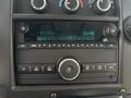Dashboard of a 2020 Chevrolet Express showing radio controls and display with FM station and time