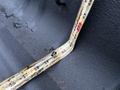 A rusted metal tape measure showing a measurement of 5 feet 8 inches laid inside the bed of a 2017 GMC Sierra 3500HD