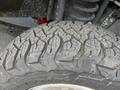 Close-up of a large off-road tire with an aggressive tread pattern mounted on a 2017 Ford F-250 SD