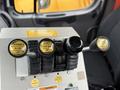 A control panel with three levers labeled down and up for plow and front wing along with two buttons for left and right flow