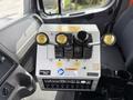 Control panel of a 2016 Freightliner 108SD with levers for adjusting down and flow settings and multiple switches below