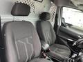 Interior view of a 2017 Ford Transit Connect showing two front seats with black fabric upholstery and a simple dashboard design