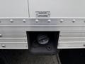 A fuel cap for a 2022 Ford E-450 with a label indicating fuel type and a tether attached to the cap