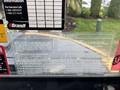A close-up view of a capacity and safety information sticker for a 2017 John Deere 50G excavator detailing load limits and operational guidelines