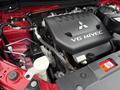A 2016 Mitsubishi Outlander engine featuring a V6 MIVEC cover with visible components including hoses and fluid reservoirs