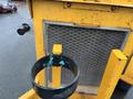 A close-up of a 1993 Bandit 200+ wood chipper featuring a metal frame with a circular holder and a mesh screen showing signs of wear and rust