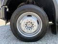 Close-up of a silver wheel and tire from a 2008 Ford F-550 showcasing the five-spoke design and tread pattern