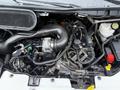 The engine compartment of a 2022 Ford Transit showcasing the engine and various mechanical components