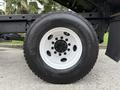 A close-up of a white alloy wheel on a 2006 International 4200 truck with a black tire featuring the Michelin brand and X Line Energy D designation