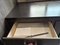 A partially open drawer in a 2021 Jayco Jay Flight with a blank notepad and a metal ruler inside