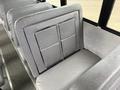 Interior seating of a 2014 Freightliner B2 bus featuring two grey padded seats with a textured finish positioned against a metal frame