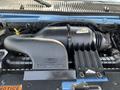 A close-up view of the engine compartment of a 2005 Ford Econoline featuring the air intake and engine components in black and gray colors