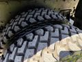 Close-up of two sturdy tires with deep treads designed for traction, part of a 2009 International 3000 CE vehicle