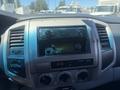 Dashboard of a 2010 Toyota Tacoma featuring a central console with a radio and climate control knobs