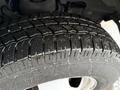 Close-up of a well-treaded tire from a 2020 Chevrolet Express showing detailed patterns and some water droplets on the surface