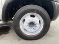 Close-up of a silver wheel on a 2011 Dodge Ram 5500 with multiple lug nuts and a black tire showing some wear