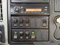 Control panel of a 2013 International Durastar 4300 featuring various switches and a digital clock displaying 126 PM