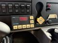 Dashboard controls of a 2011 International 4300 including a display panel with buttons for dimmer, left, right, center, and flash functions