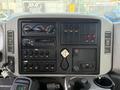The dashboard of a 2008 International 4300 featuring various gauges switches and controls including a radio and multiple toggle switches