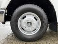 A close-up of a silver wheel with a rugged tire from a 2008 Ford F-350 showcasing the wheel design and tread pattern