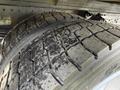 Close-up of two worn tires from a 2014 Hino 195 showing visible tread patterns and signs of wear