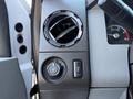 Dashboard controls and air vent of a 2011 Ford F-550 showing various dials and buttons