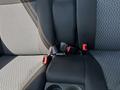 The image shows the rear seat of a 2011 Chevrolet Colorado with black and gray fabric upholstery and a seatbelt buckle visible in the center