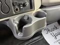 A gray cup holder with two compartments located in the cabin of a 2011 International WorkStar truck
