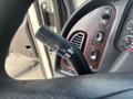 Close-up of the control lever for lights and wipers in a 2010 Freightliner M2 106 with buttons for various functions on the dashboard