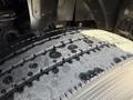 A close-up of a wet tire tread from a 2008 Kenworth T370 showing detailed patterns and grooves for traction