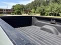 A 2016 Chevrolet Silverado 2500HD with a textured black truck bed showing grooves and contours for cargo security and durability