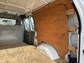 Interior of a 2013 Ford Econoline van featuring wooden paneling and a flat wooden floor providing a cargo space look