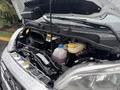 The engine compartment of a 2023 RAM Promaster 3500 with visible components like hoses and a coolant reservoir