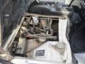 View of the engine compartment of a 2010 Daihatsu Hijet showing the engine components and surrounding parts