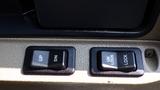 Two black control buttons on a beige panel labeled UP DN and UNLOCK LOCK