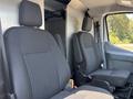 Two black fabric front seats of a 2019 Ford Transit 350 are positioned side by side with adjustable headrests and armrests