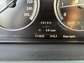 Dashboard display of a 2013 BMW X3 showing temperature fuel consumption speed odometer and door status