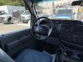 Interior view of a 2013 Ford Econoline showing the steering wheel dashboard and front seat