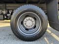A close-up view of a 2010 Ford F-450 wheel showcasing the tire tread and metal rim with lug nuts