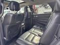 Interior view of a 2015 Dodge Durango showing black leather back seats with a spacious layout and integrated storage pockets