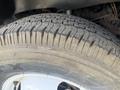 Close-up of a tire tread on a 1976 GMC Palm Beach showcasing its grooves and markings