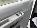 Close-up of the door control panel of a 2013 Ford E-350 featuring window control buttons and a textured grip area
